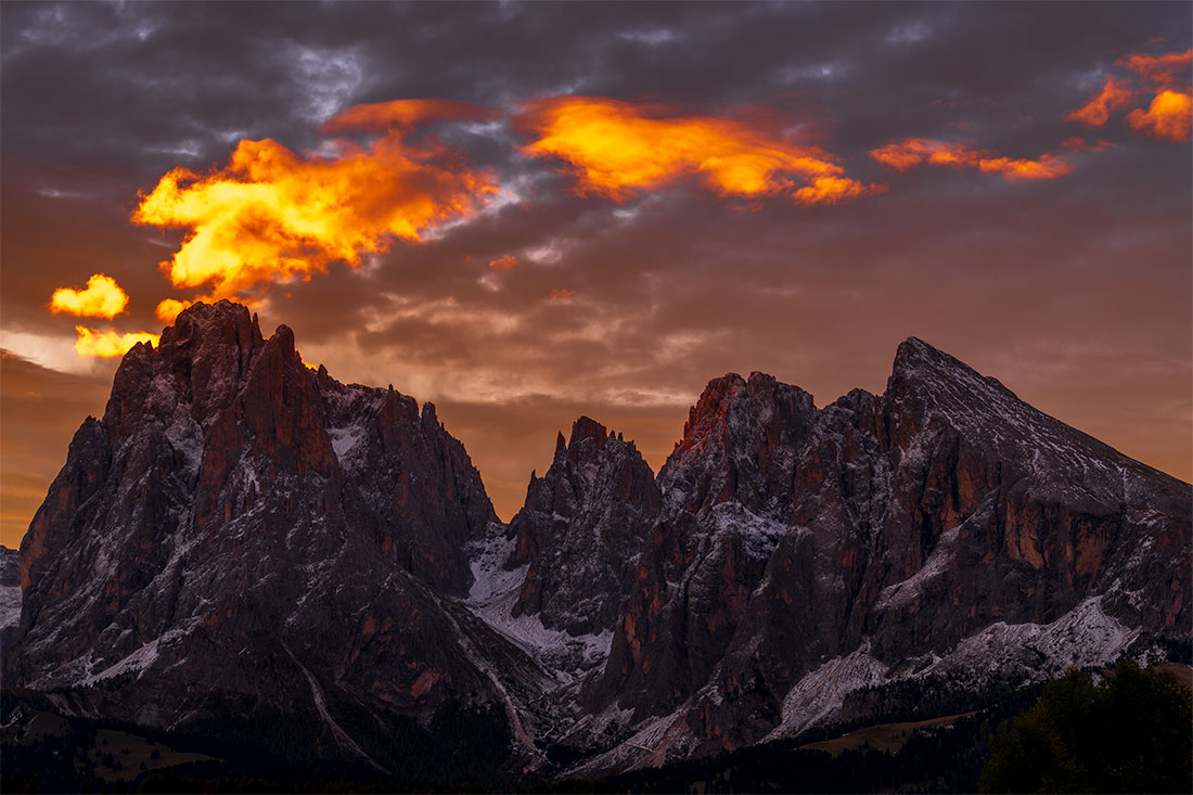 Sunrise clouds above snow-dusted peaks at Alpe di Siusi in the Dolomites