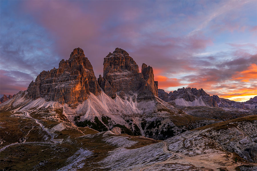 Sunset light on the jagged peaks of Cadini di Misurina under clouds in the Dolomites