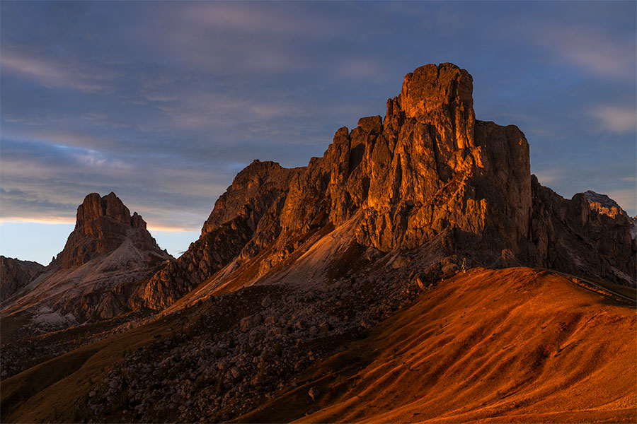 Sunset light on peaks and rolling hills at Giau Pass in the Dolomites