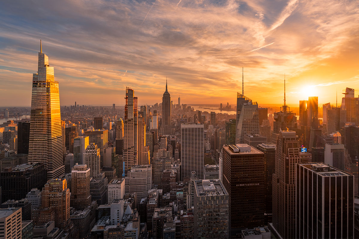 New York City skyline at golden hour during a photography workshop, with warm light and architectural foreground