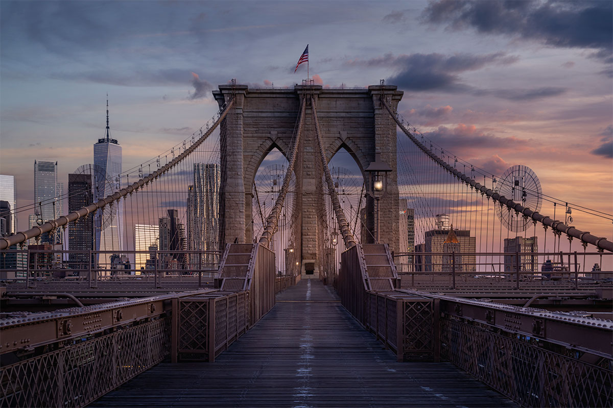 Brooklyn Bridge at dawn with the New York City skyline in the background