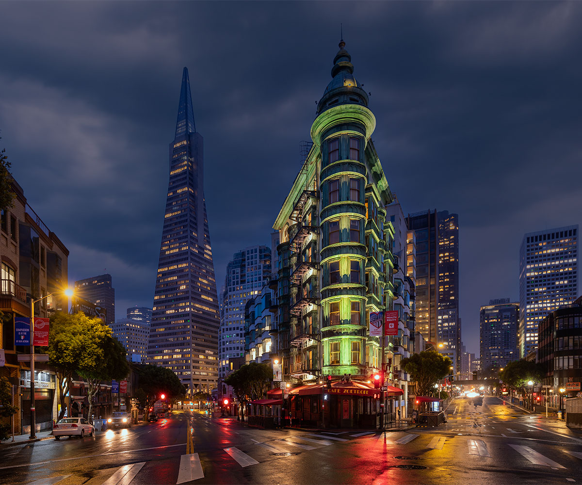 Transamerica Pyramid rising behind the Flatiron Building in San Francisco at night